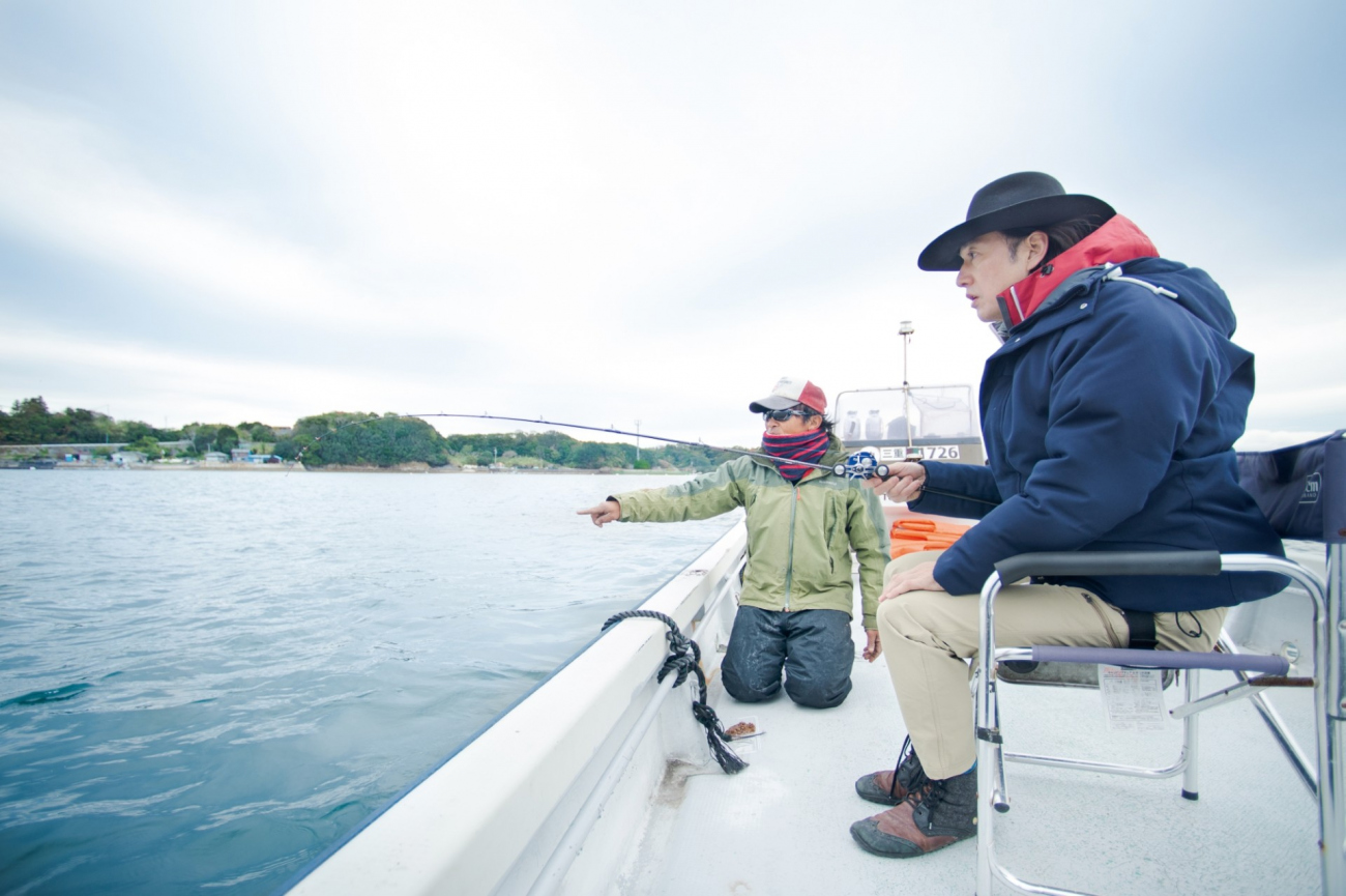 釣りのポイントを伝える船頭の田畑 圭一さん（左）は、渡船業の他にもあおさや牡蠣の養殖漁業も営む